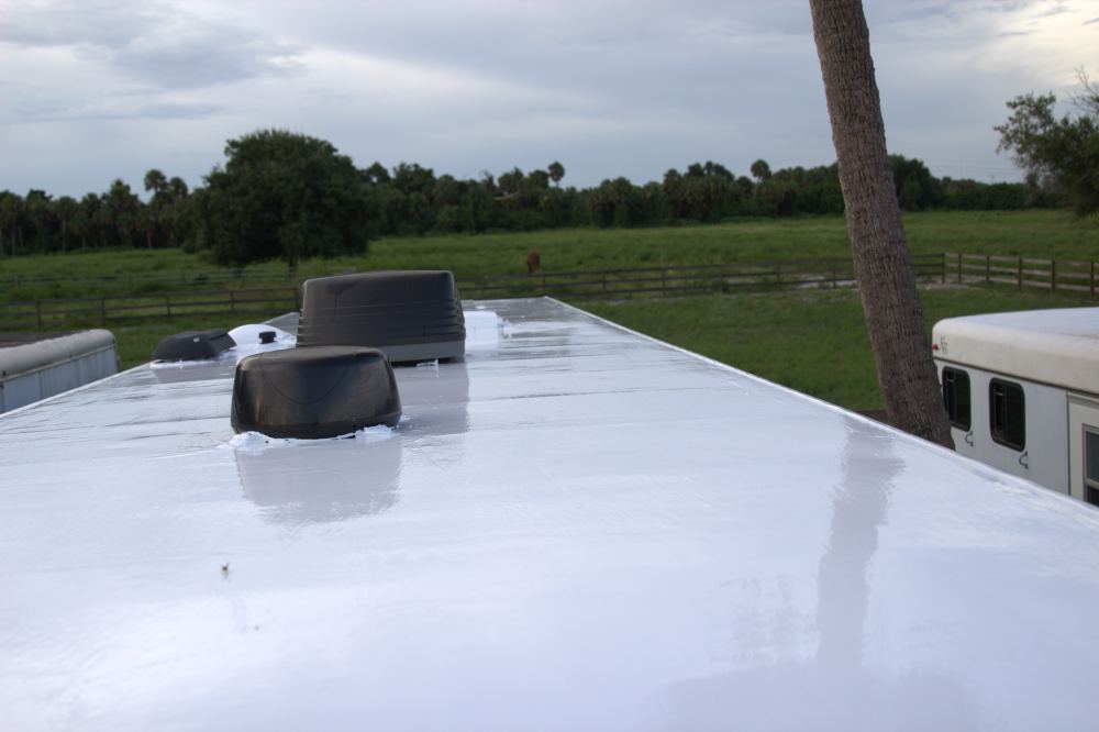 Finished silicone roof coating on a horse trailer, sealed around the vents