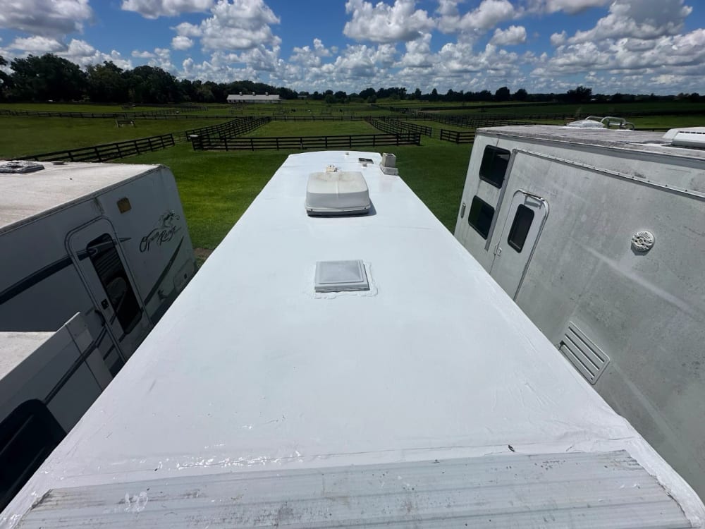 The same RV roof after high-solids silicone coating, clean and white
