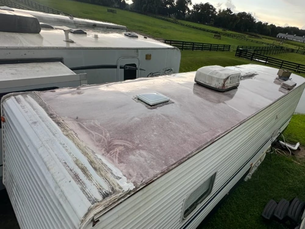 Weathered RV roof, heavy chalky oxidation and a split, lifting front seam